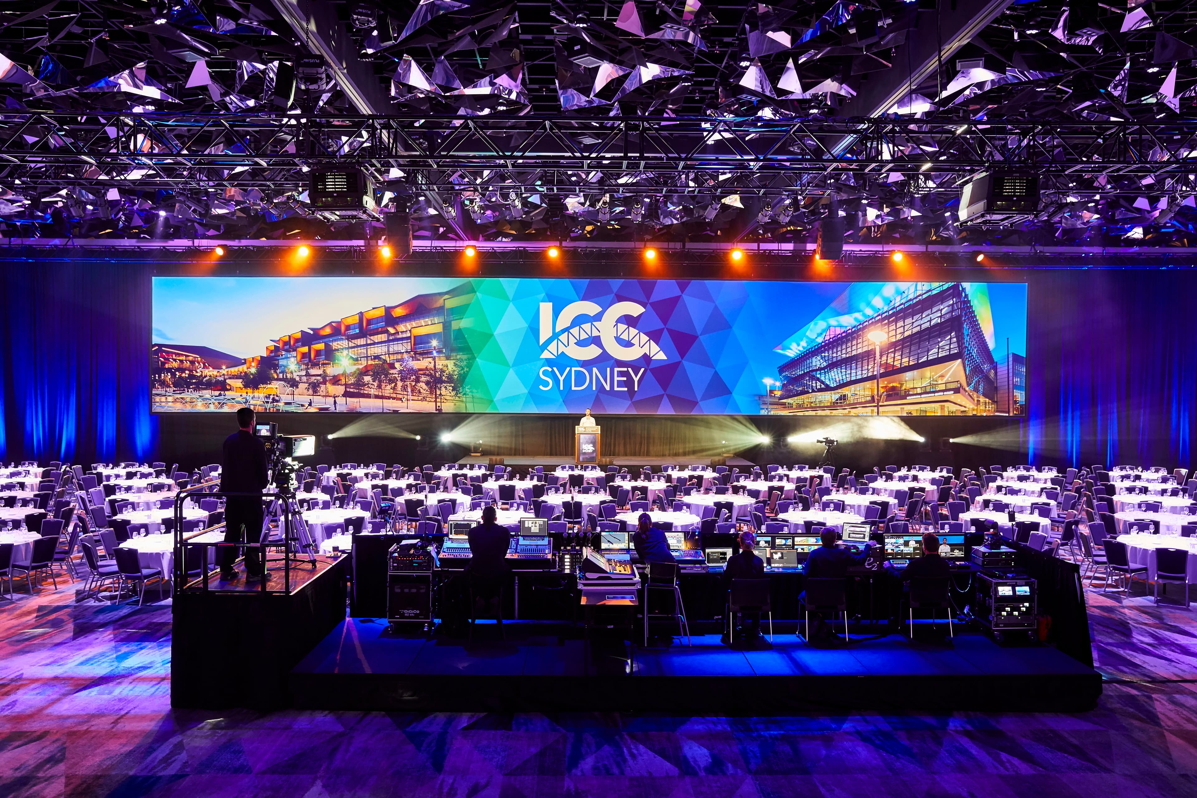 Speaker presenting onstage at a business conference