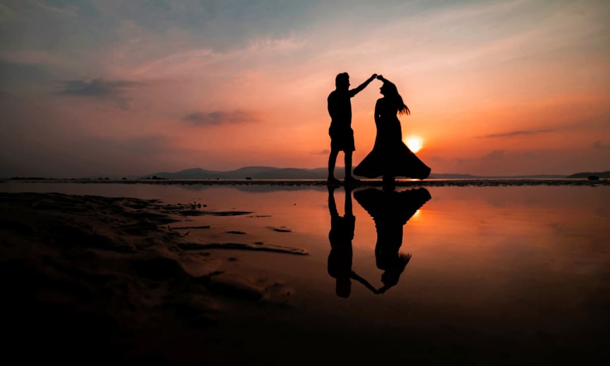 Couple embracing during an engagement session by the water