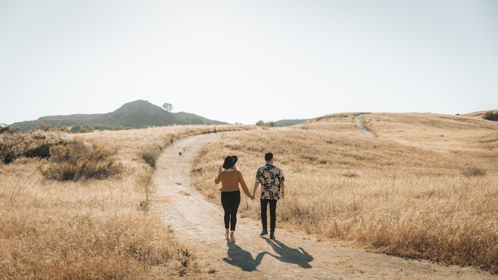 Couple embracing during an engagement session by the water