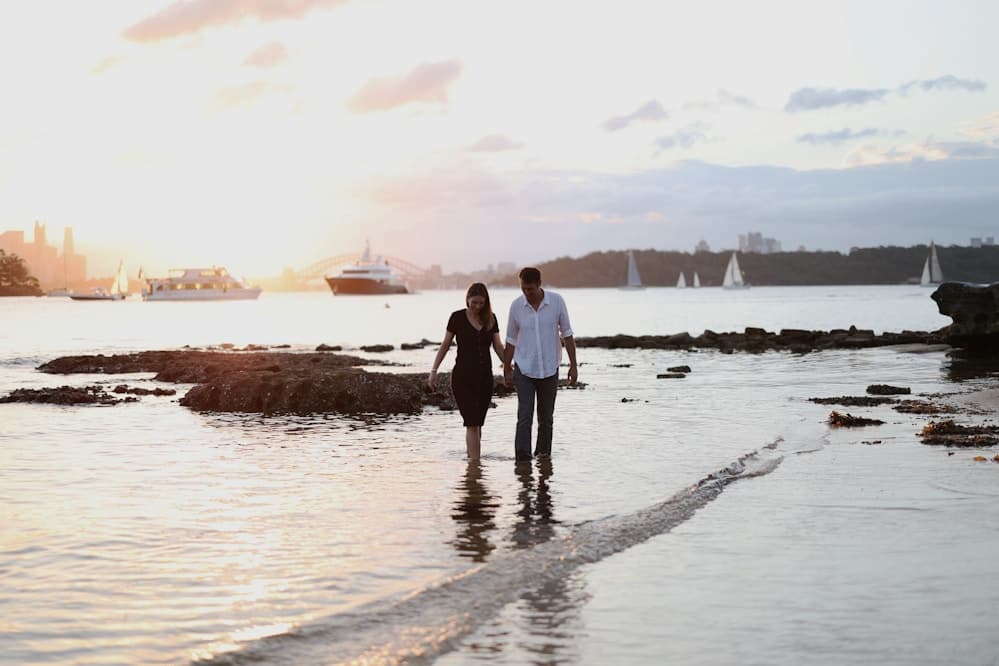 Couple holding hands and walking through a park
