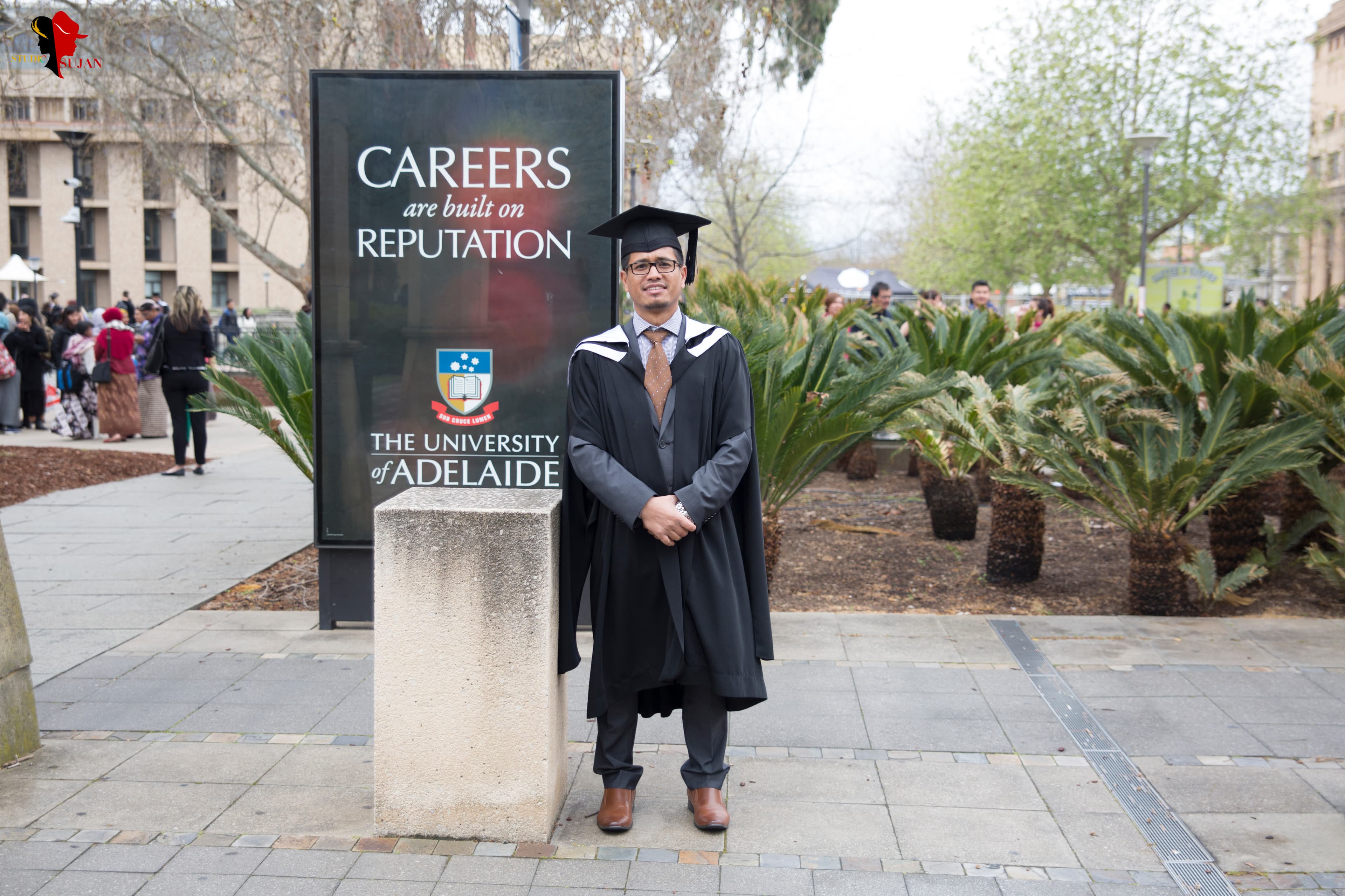 Graduates standing together in caps and gowns for a group photo