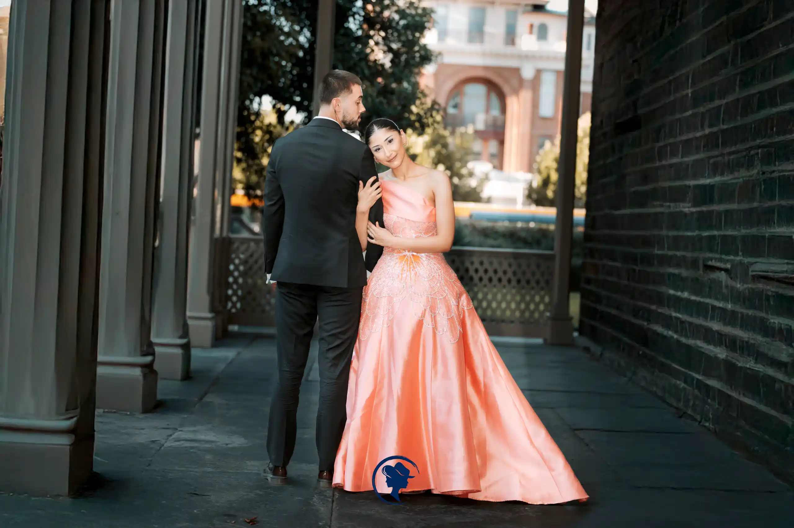 Bride and groom by a pool with palm trees