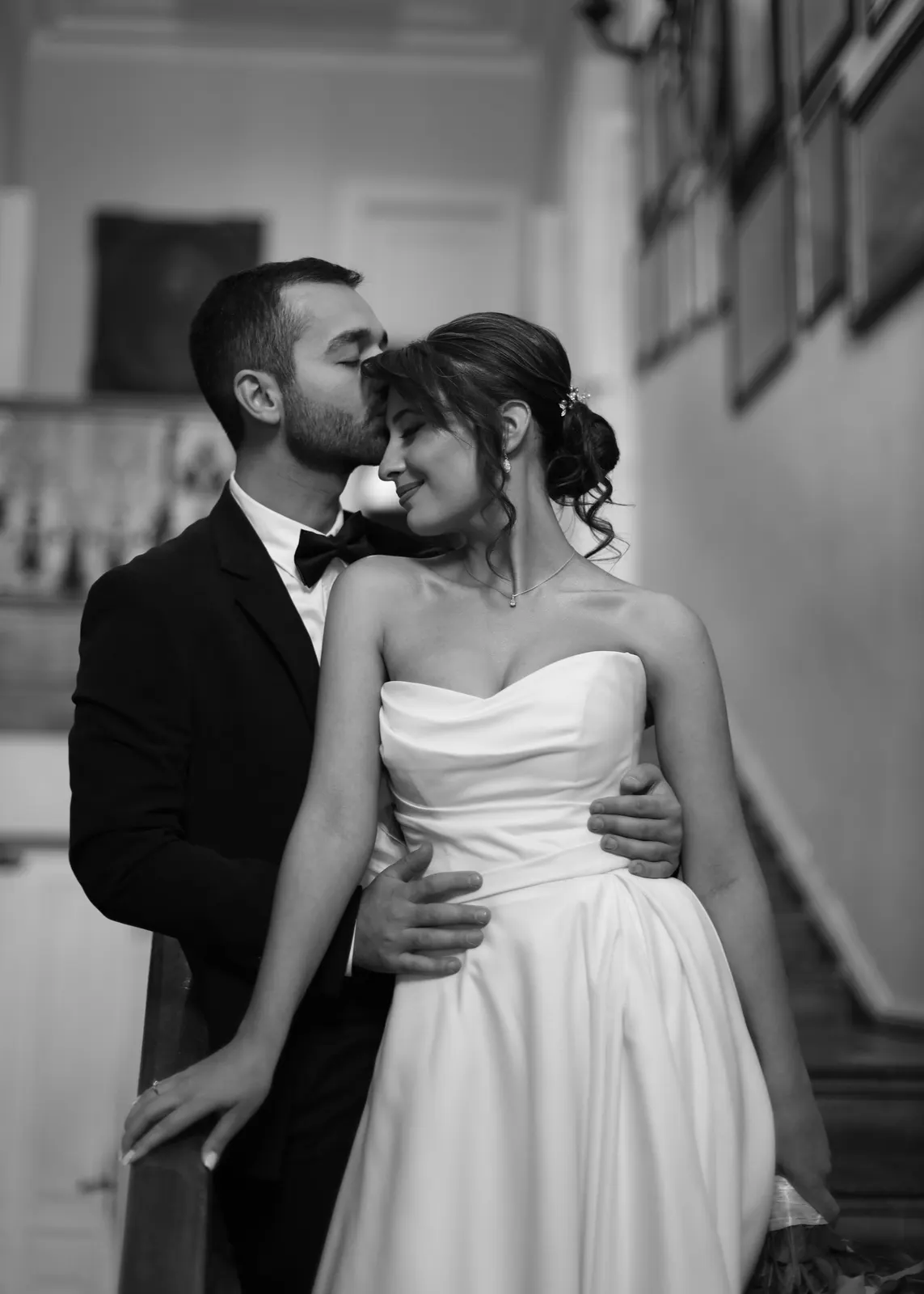 Bride and groom kissing framed by palm shadows