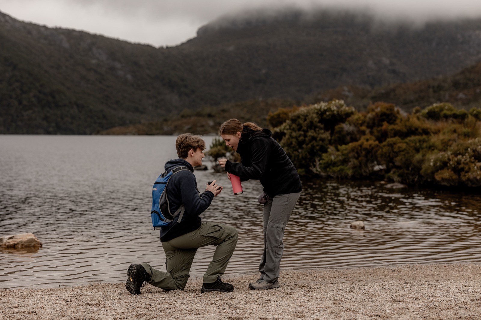 Couple at the moment of the proposal on the lake shore at Cradle Mountain, Tasmania